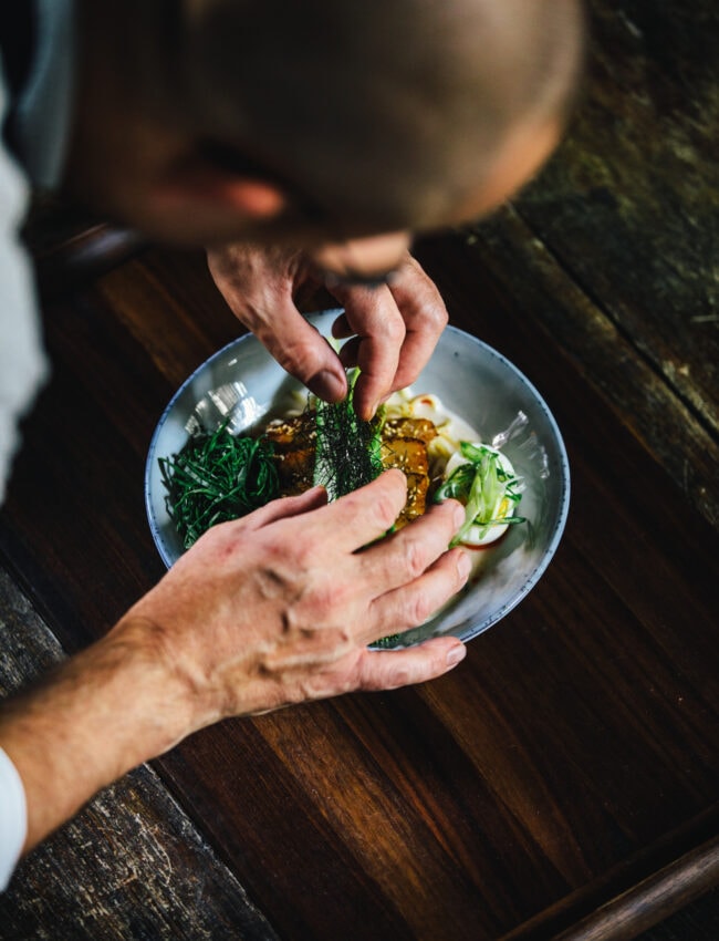 Chef preparing the Ramen dish at Bar Brasserie OCCO at The dylan Amsterdam luxury boutique hotel, Leading Hotels of the World.