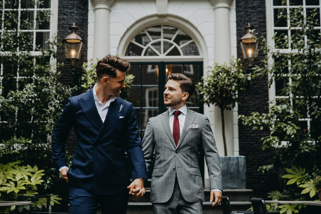 A married copple walking into the secluded garden of Bar Brasserie OCCO in luxury boutique hotel The Dylan Amsterdam.