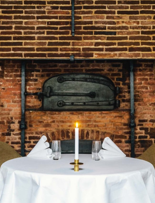 A table next to the old bakery oven, in 2 star Michelin restaurant Vinkeles, in luxury boutique hotel The Dylan Amsterdam.