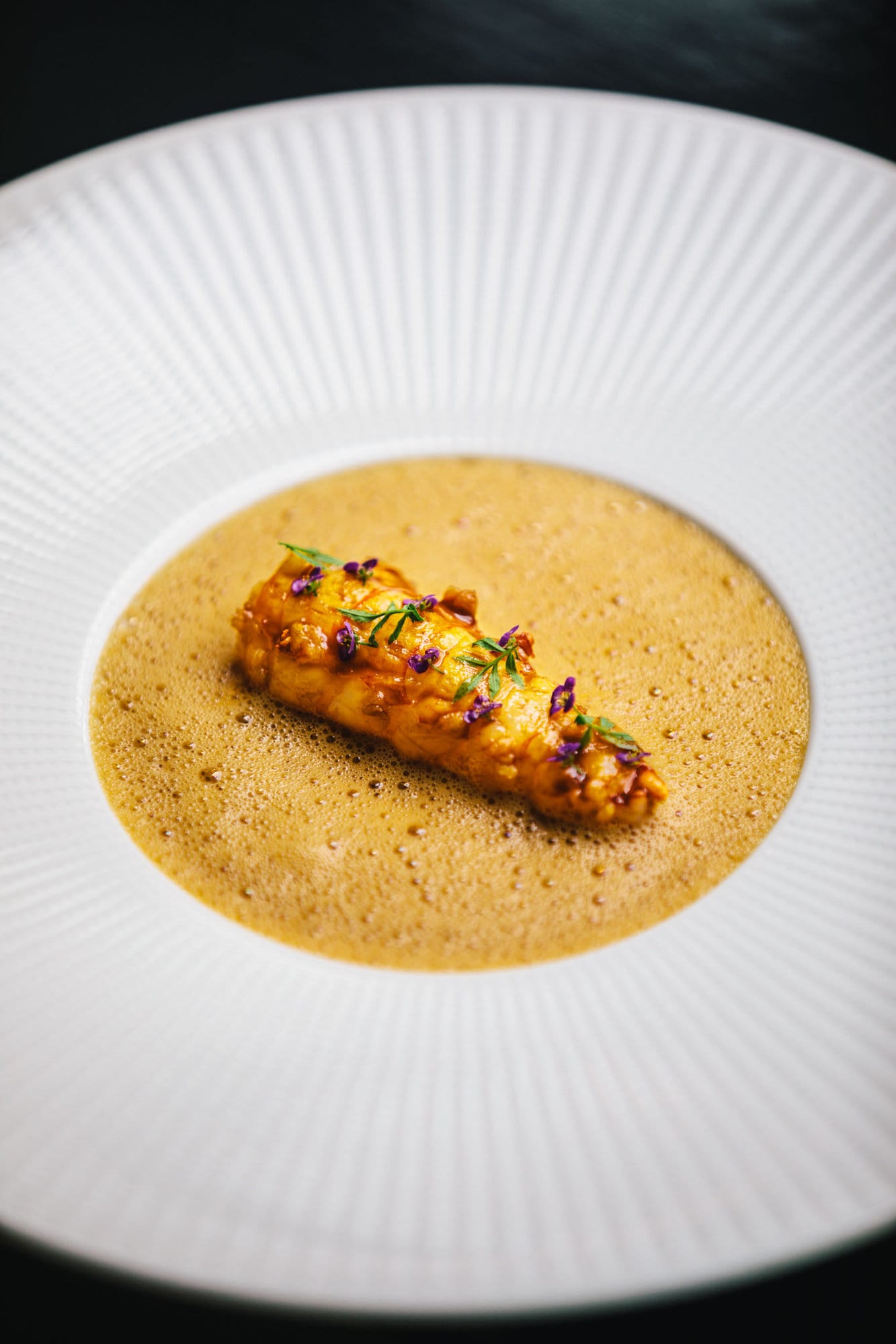 A langoustine dish at Michelin star restaurant Vinkeles in luxury boutique hotel The Dylan Amsterdam, member of The Leading Hotels of The World.