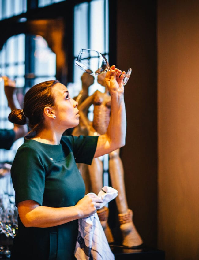 Natasja Noorlander, maitre sommelier at The Dylan in Restaurant Vinkeles, holidng a glass to see if it is well polished.