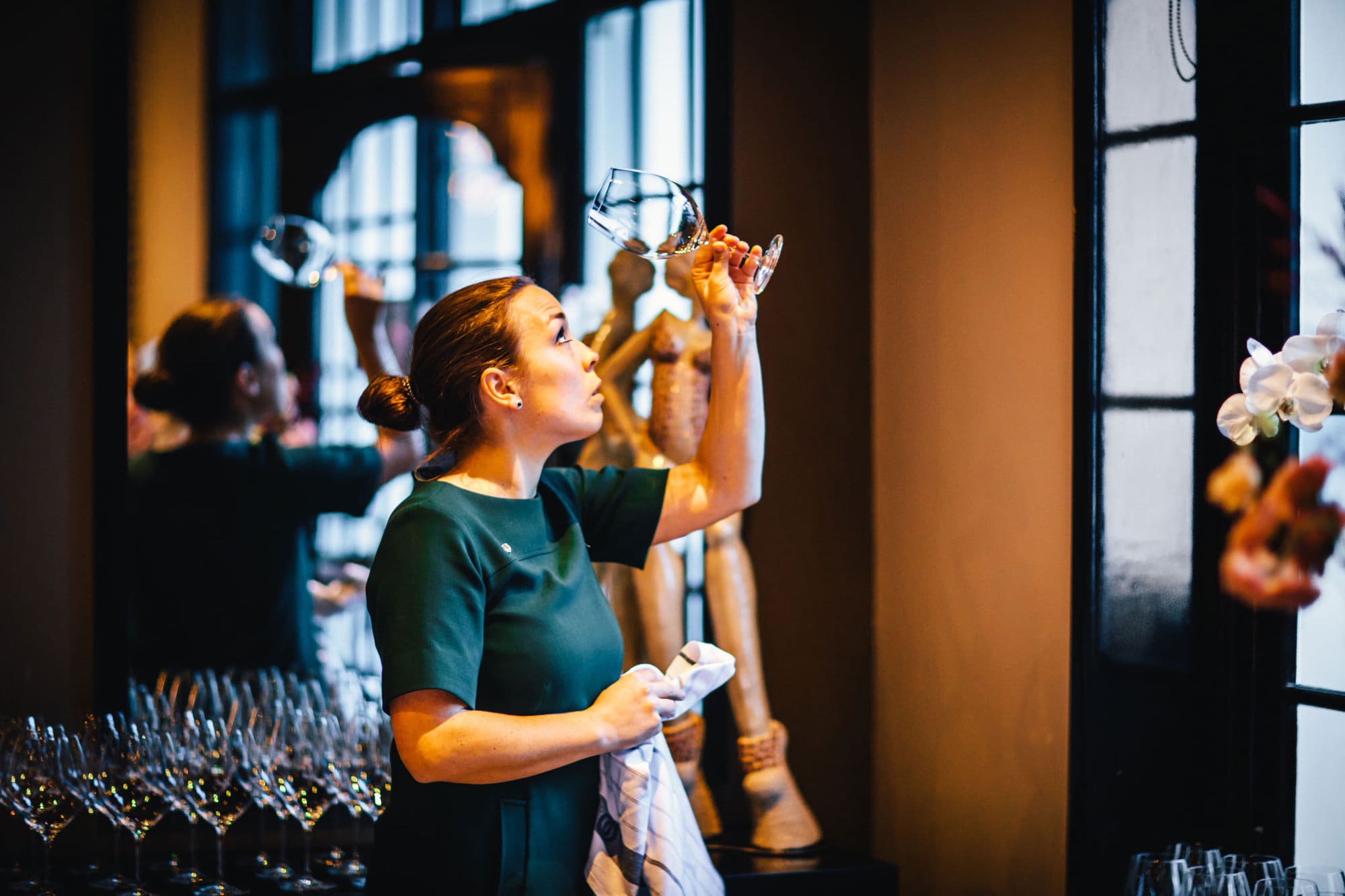 Natasja Noorlander, maitre sommelier at The Dylan in Restaurant Vinkeles, holidng a glass to see if it is well polished