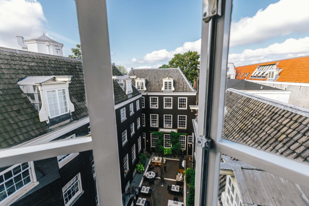 View from our newly renovated loft style suites in luxury boutique hotel The Dylan Amsterdam, member of the Leading Hotels of the World. View on the secluded garden of Bar Brasserie OCCO.